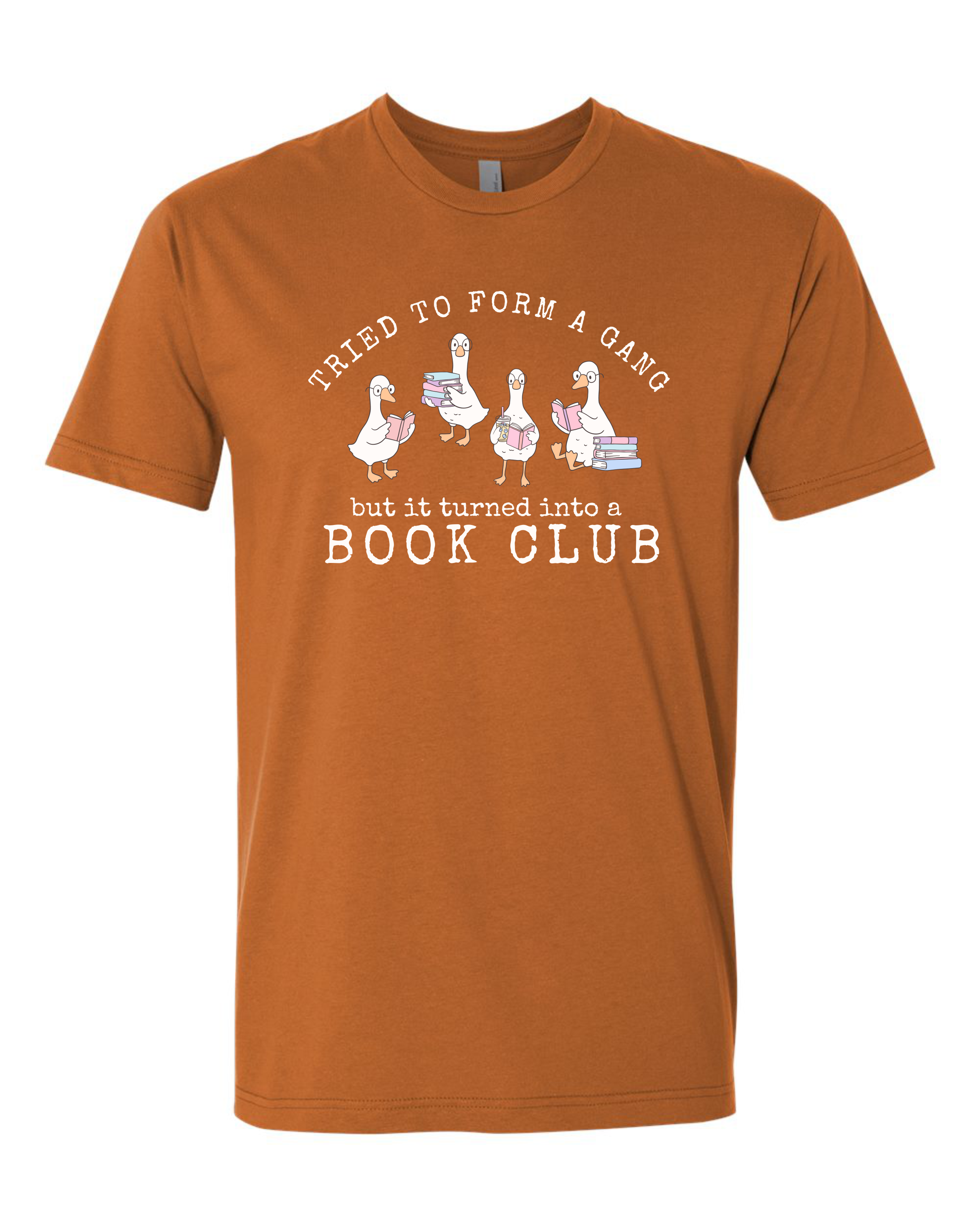A clay short-sleeve crewneck t-shirt with a graphic print on the front. The graphic features four cartoon geese holding stacks of books, with the text 'Tried to form a gang but it turned into a BOOK CLUB' in white.